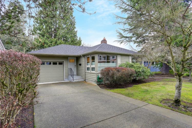 A home in Seattle with various sized trees that add to the curb appeal.